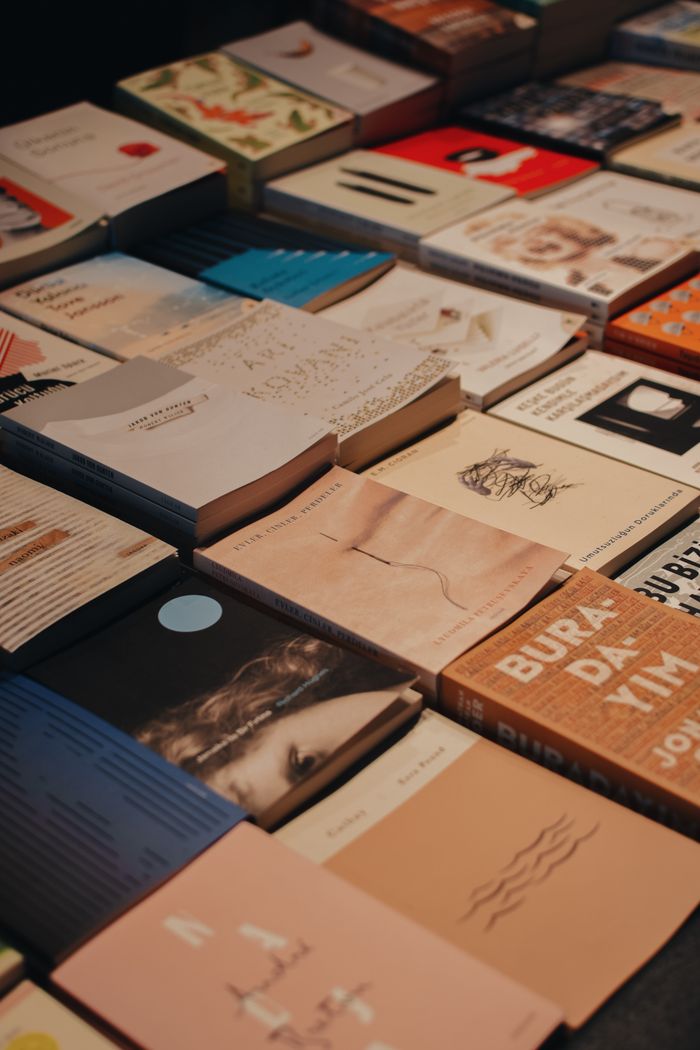 quality-assurance-02 Diverse collection of books arranged on a table inside a bookstore, showcasing various cover designs.